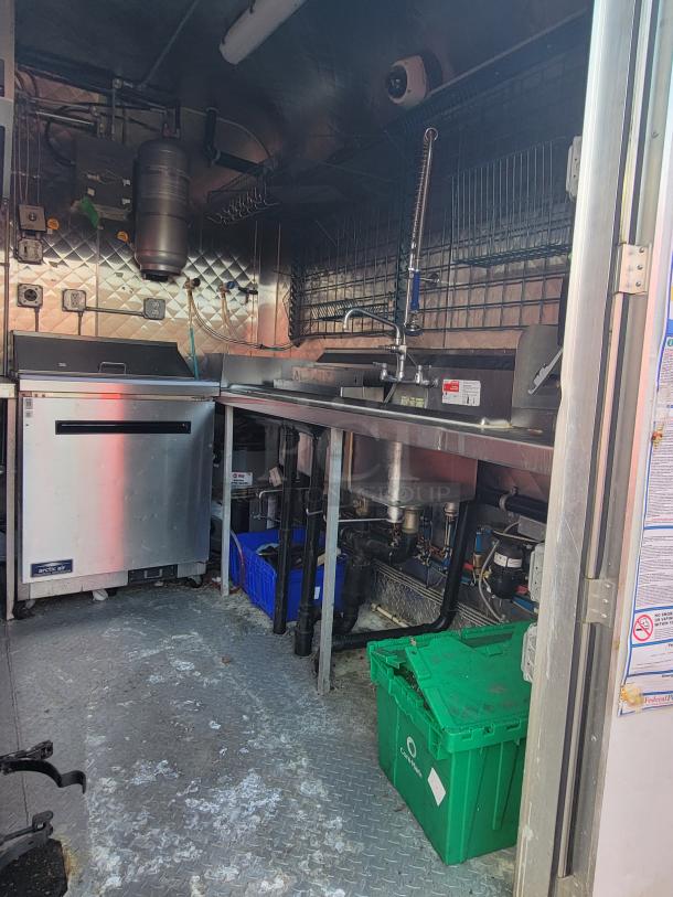 2021 16-foot Quality kitchen trailer, pristine condition, featuring stainless steel appliances, dual sinks, and spacious counter space.