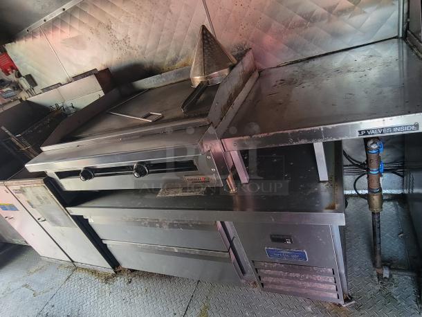 2021 16-foot Quality kitchen trailer interior, featuring stainless steel appliances and Arctic Air refrigeration.