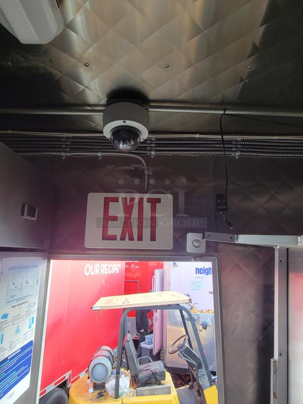 Interior of 2021 Quality 16-Foot Kitchen Vessel with exit sign, security camera, and exterior view. Ideal for catering.