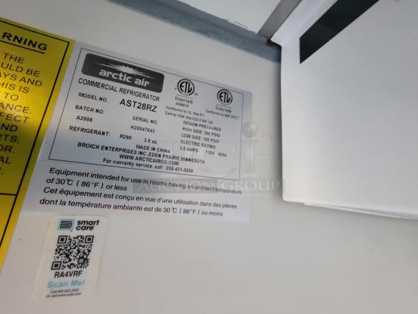 Label on commercial refrigerator shows model number AST28RZ, batch A2006, and serial H20047463 by Arctic Air.