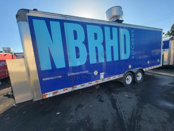 Quality 24' mobile kitchen trailer marked "NBRHD Kitchens." Blue exterior, equipped for high-volume culinary operations.
