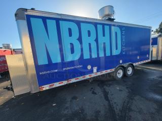 Quality 24' mobile kitchen trailer marked "NBRHD Kitchens." Blue exterior, equipped for high-volume culinary operations.