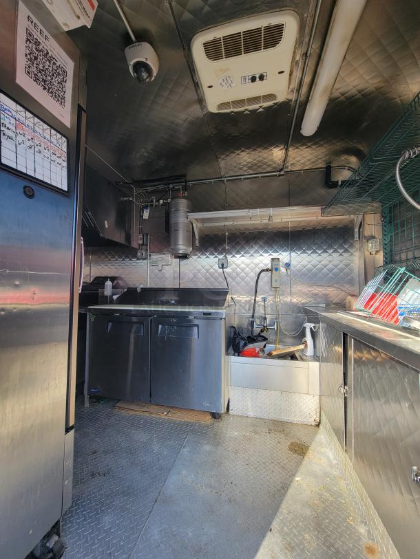 Turnkey 2020 24' food trailer interior with stainless steel kitchen, commercial equipment, and listed inspection QR code.