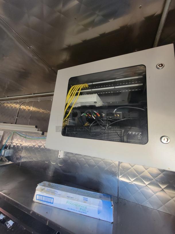 Electrical panel inside a fully equipped 2020 Quality 24' mobile kitchen trailer. Features robust wiring and network setup.