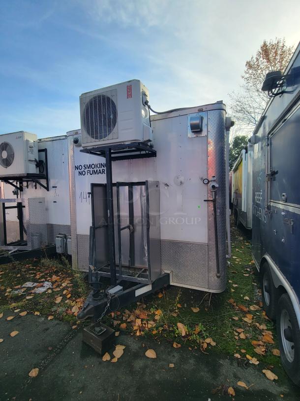 2019 Quality 24' food concession trailer with air conditioning unit. Features a tandem axle frame and "No Smoking" sign.