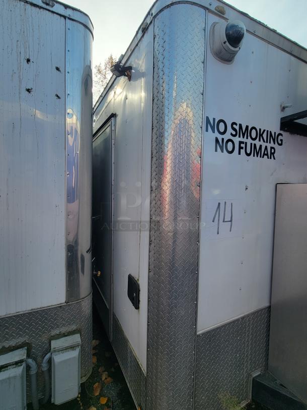2019 Quality 24' food concession trailer, exterior view, no smoking sign, tandem axle, commercial-grade build.