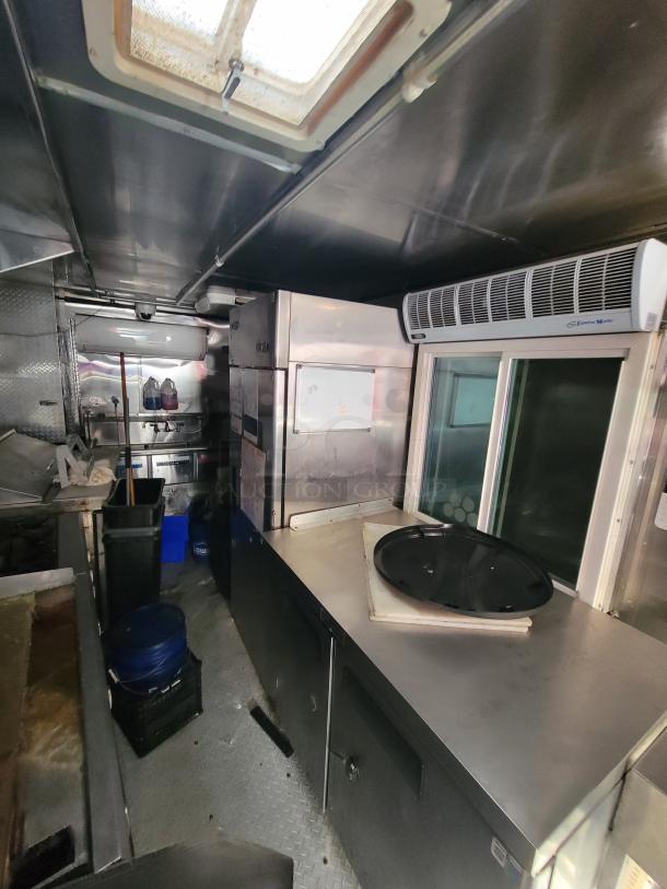 2019 Quality 24' food concession trailer interior featuring commercial kitchen equipment, including stainless steel appliances and prep tables.