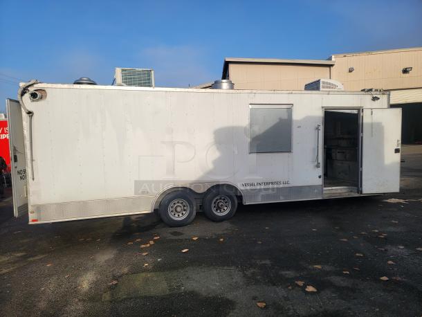 2019 Quality 24' food concession trailer, fully equipped kitchen, tandem axle, open door revealing interior, Vessel Enterprises LLC marking.