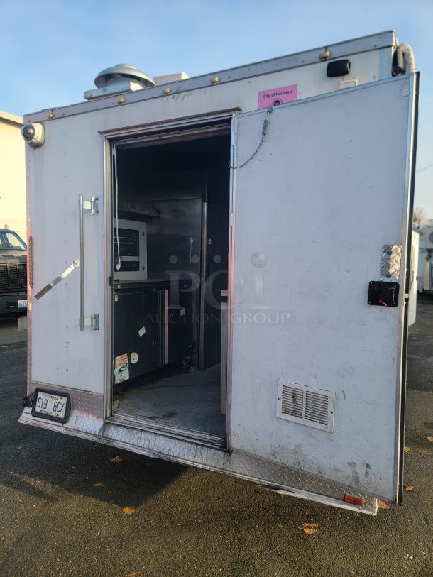 2019 24' Quality food concession trailer, exterior view, open door showing interior kitchen equipment, City of Houston tag visible.