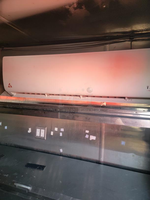 Interior of a 2019 Quality 24' food concession trailer, showing part of the kitchen setup with a stainless steel counter and electrical outlets.