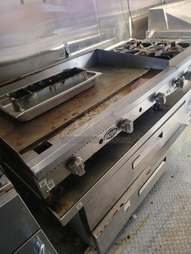 Royal gas range/griddle in 2019 Quality 24' food trailer, showing light wear. Features include commercial-grade knobs and robust build.