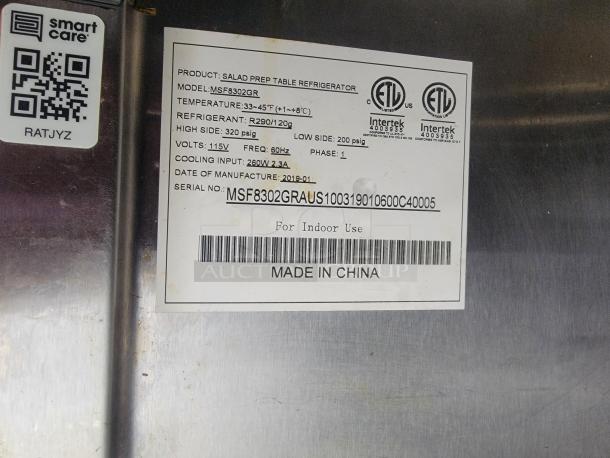 Label on food concession trailer refrigerator indicating model MSF8302GR, temperature range 33-45°F, and power specs.