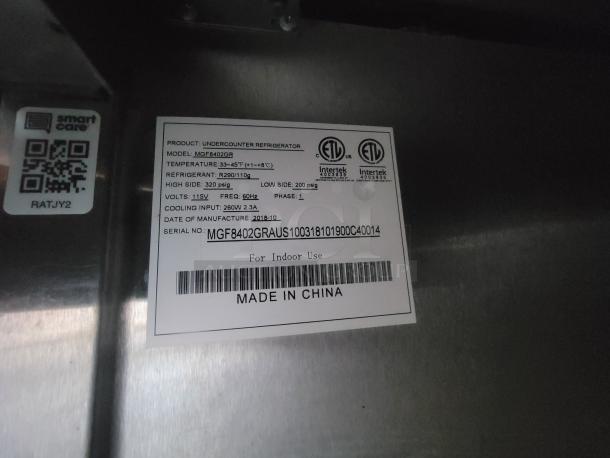 Label on stainless steel vertical refrigerator detailing model MGF8402GR, temperature range 33-45°F, and refrigerant R290/110g.