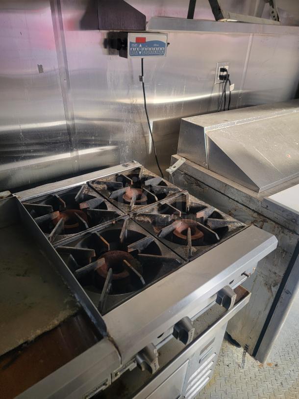2019 Quality 24' food concession trailer interior showing Royal gas range/griddle and stainless steel setup.