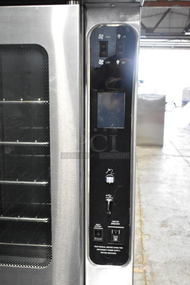Blodgett MARK-V-100 stainless steel convection oven with view-through doors, metal racks, and control panel. In good condition.