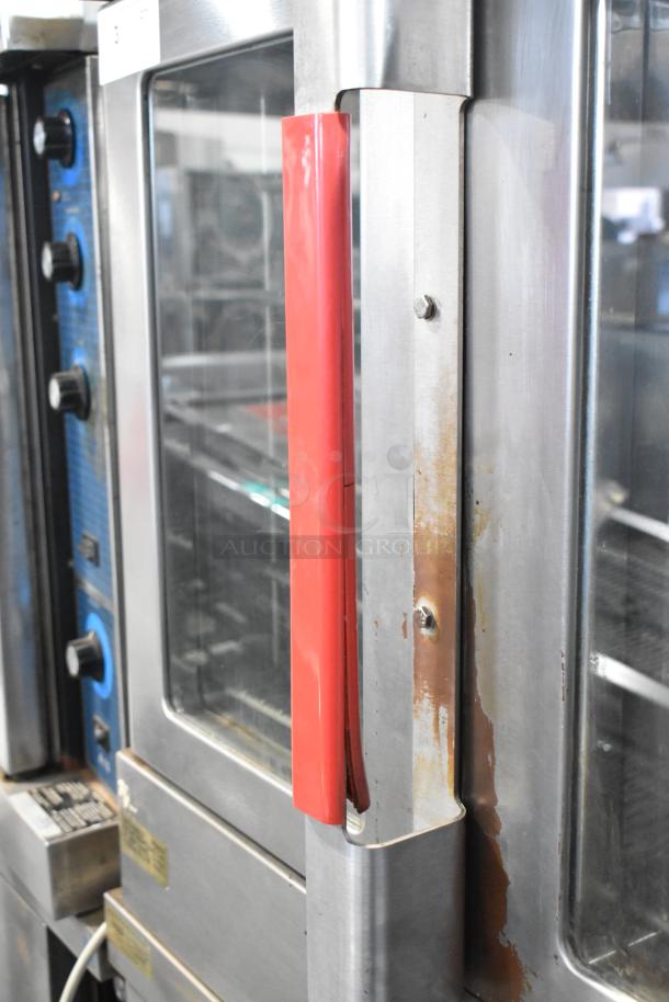 Vulcan VC6GD stainless steel convection oven with view-through doors, thermostatic controls, and metal racks. Visible wear.