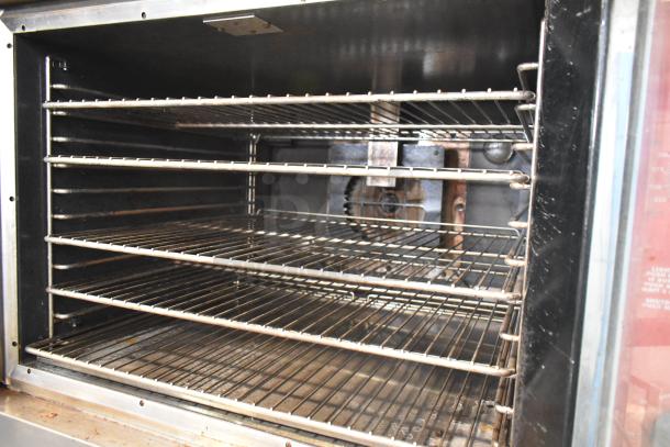 2 Vulcan VC6GD stainless steel convection ovens with view doors, metal racks, thermostatic controls. Commercial-grade.