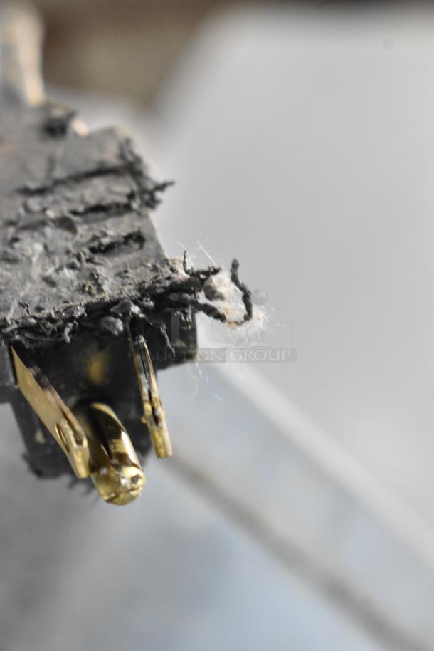 A close-up of a worn electrical connector with frayed cables, showing signs of damage and wear.