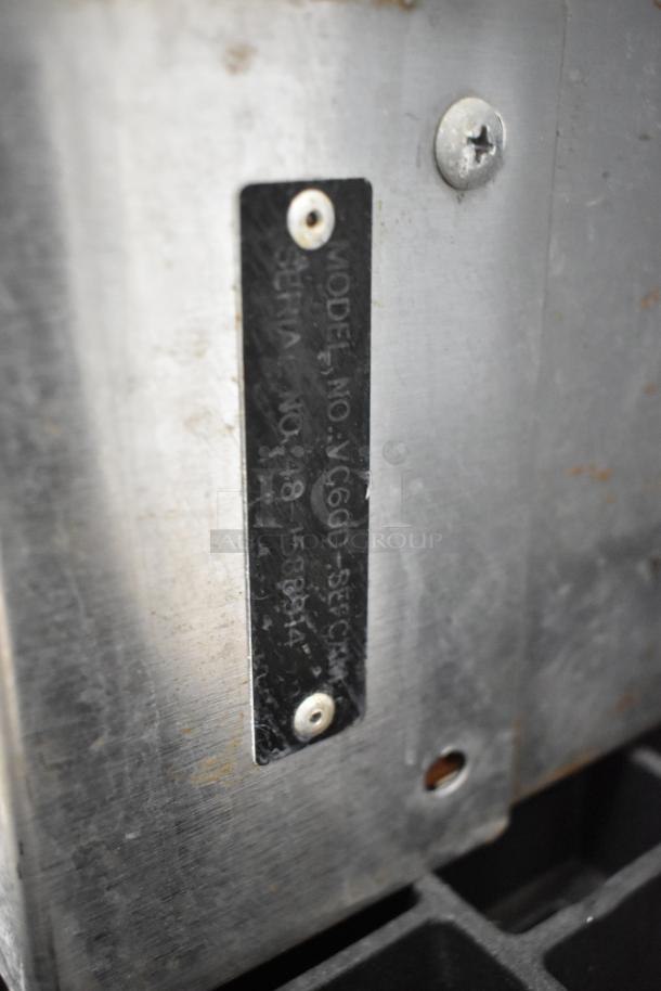 Vulcan VC6GD convection oven, stainless steel, electric, view-through doors, metal racks, thermostatic controls, model tag visible.