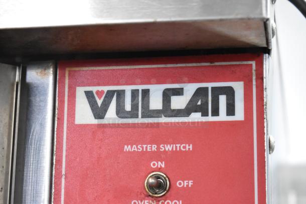 Close-up of Vulcan VC6GD oven control panel showing logo and master switch.