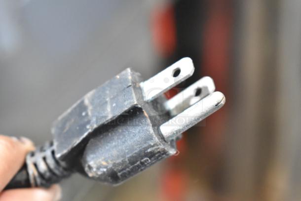 Close-up of a three-pronged electrical plug.