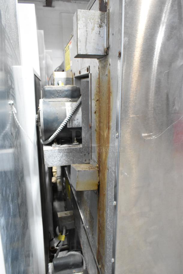 Stainless steel side of Vulcan VC6GD-SEFCAM convection oven, visible wear and rust, motor and wiring shown.