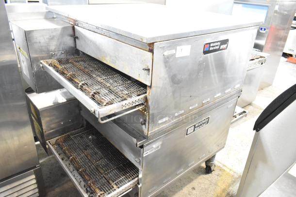 Pair of 2021 Middleby Marshall PS638G stainless steel commercial gas conveyor pizza ovens, 89,000 BTU, on casters.