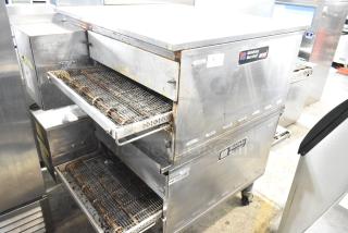 Pair of 2021 Middleby Marshall PS638G stainless steel commercial gas conveyor pizza ovens, 89,000 BTU, on casters.