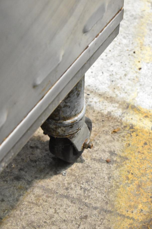 Close-up of a Middleby Marshall PS638G pizza oven's commercial caster. Shows wear and rust on the metal fittings.