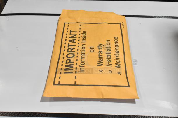 Yellow envelope labeled "IMPORTANT: Information Inside on Warranty, Installation, Maintenance" for Scotsman MC1030SA-32A.