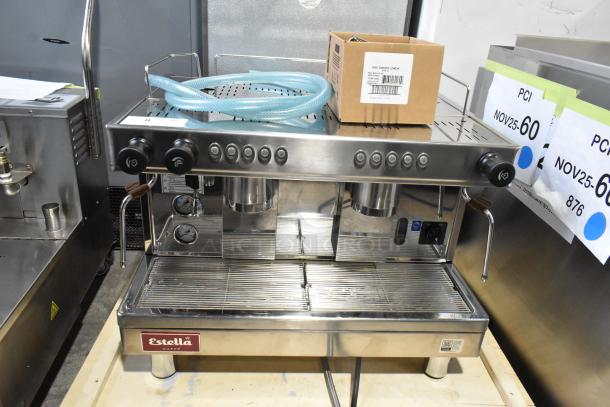 Estella ECEM2 stainless steel espresso machine, new, with scratches. Includes 3 portafilters, steam wands, and hoses. 220-240V, 1 phase.