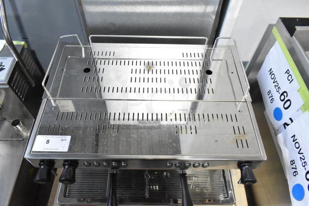 Brand new Estella ECEM2 stainless steel commercial espresso machine, two groups, three portafilters, steam wands, 220-240V, 1 phase.