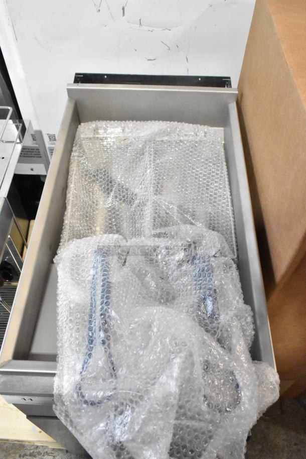 Brand new Imperial IFS-40-E deep fat fryer, stainless steel, 208V, 1 phase, with 2 metal fry baskets, wrapped in bubble wrap.