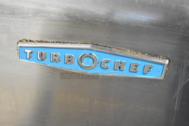 Turbochef HhC2020 stainless steel logo with visible wear on commercial conveyor oven.