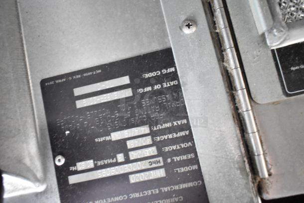 Turbochef HhC2020 label indicating model, serial, voltage, and phase details. Stainless steel surface visible.