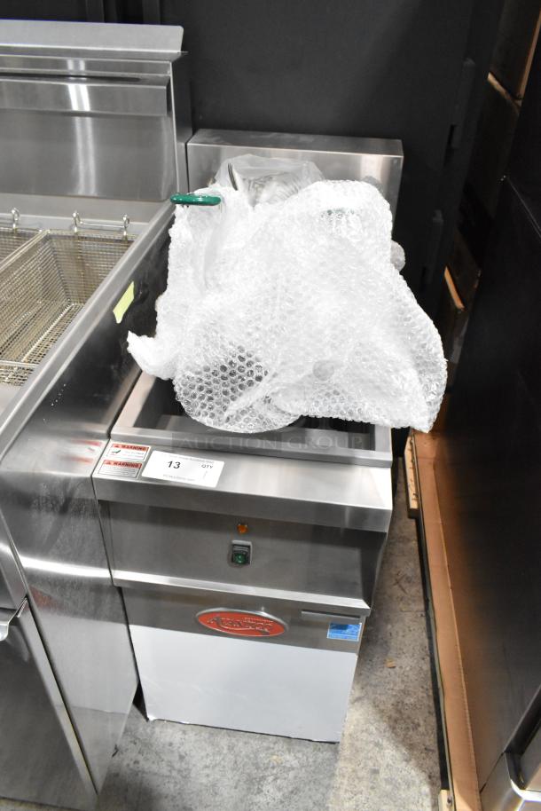 Brand new Avantco 177EF40B stainless steel electric deep fat fryer with two metal baskets, partially wrapped. Scratch and dent condition.