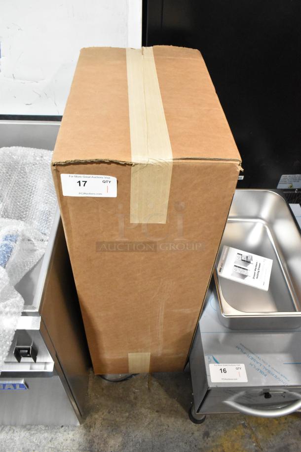 Cardboard box containing a brand new 2023 Fetco TBS-2121 iced tea brewer. Box has auction sticker "17." Scratch and dent condition.