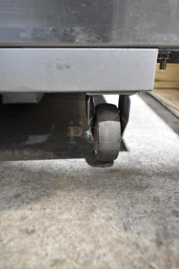 Fryclone 259OFM85 stainless steel fryer oil filter machine wheel on commercial caster, showing detail and condition.