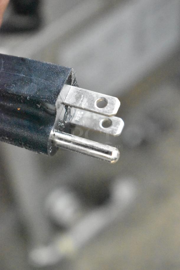 Close-up of a plug for the Fryclone 259OFM85 fryer oil filter machine. 120 volts, 1 phase. Commercial-grade black casing.