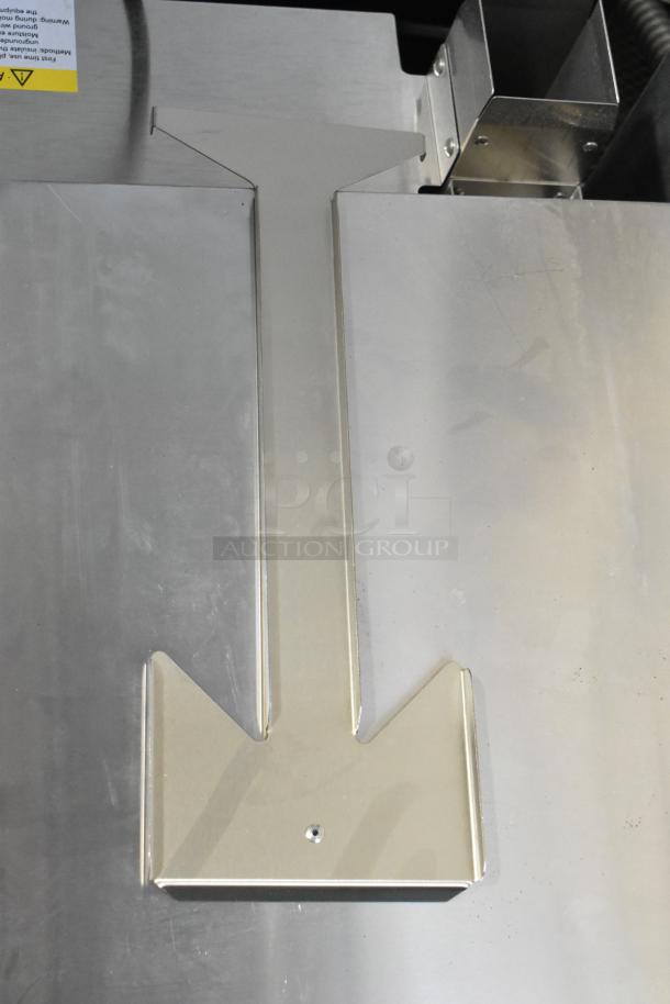 Stainless steel exterior of the Cooking Performance Group CPG 351ICOED countertop electric pizza oven, showing minor scratches.