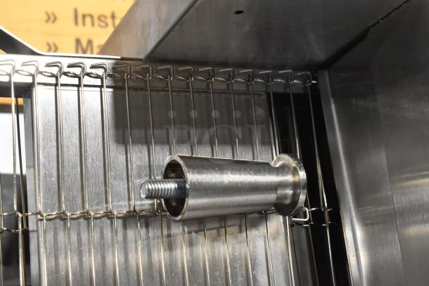 Stainless steel interior component of Vollrath JT2000 conveyor toaster, showing metal rod and wire rack design detail.
