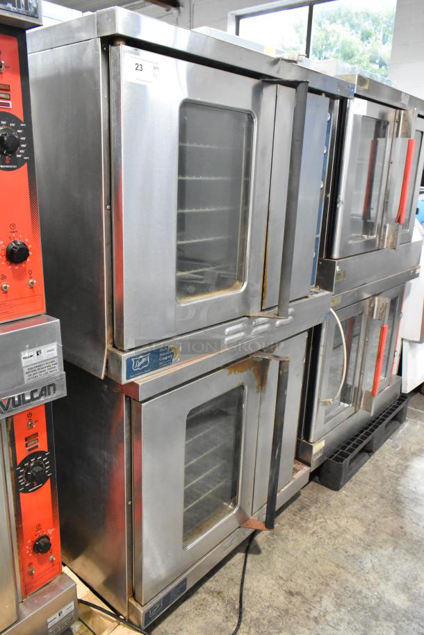2 Duke 613-G2V stainless steel convection ovens with view-through and solid doors, metal racks, and thermostatic controls.