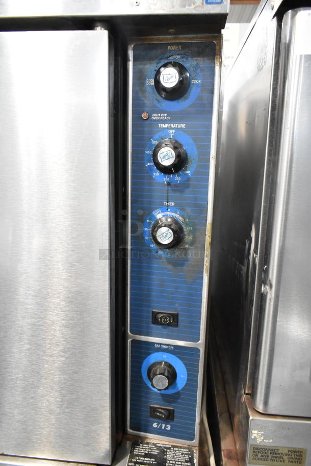 Duke 613-G2V stainless steel convection oven with view-through door, solid door, metal racks, and thermostatic controls.