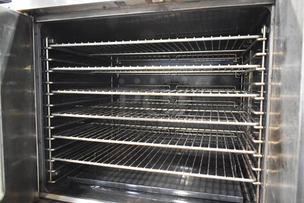 Duke 613-G2V stainless steel convection oven interior with metal racks, view-through door, and thermostatic controls.