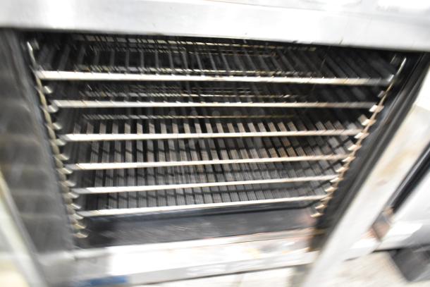 Duke 613-G2V Stainless Steel Convection Oven with racks and view-through and solid door, features thermostatic controls.