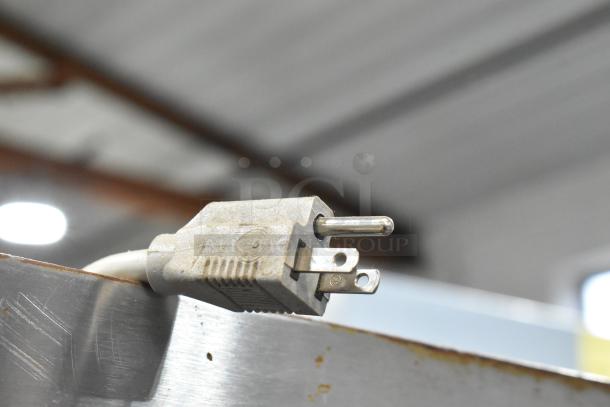 A close-up of an electrical plug attached to a Duke 613-G2V stainless steel commercial convection oven, showing detail.