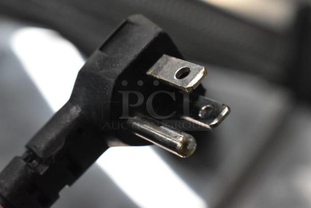 Close-up of a plug for a 2023 Traulsen UHT27R0-0300 single door undercounter cooler, showing three prongs.