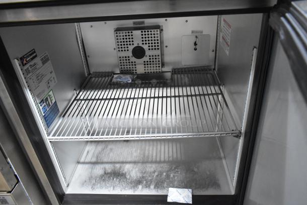 2024 True TUC-27-HC stainless steel undercounter cooler, single door, commercial casters, 115 volts. Interior label visible.