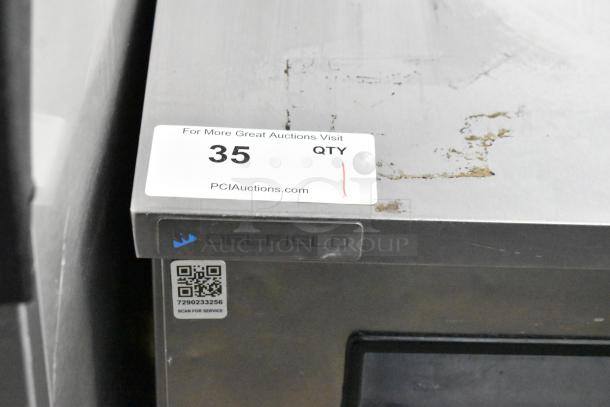 2019 Delfield stainless steel single-door undercounter cooler on casters with sticker displaying "35 QTY" and QR code.