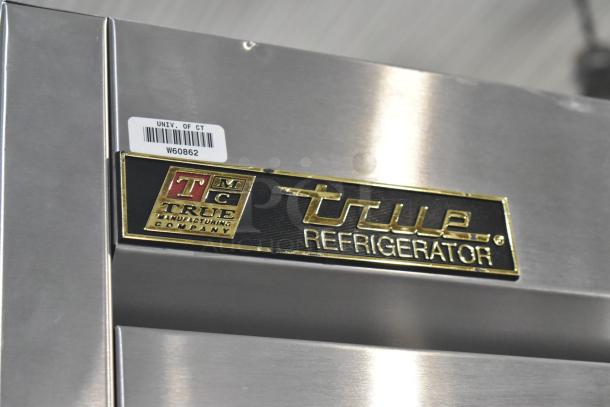 True TS-43 stainless steel commercial cooler with two doors, model TS-43. Features brand plate with logo and university label.